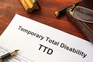 a piece of paper on a table that says "Temporary Total Disability"