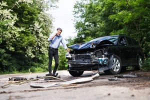 man examining vehicle damage