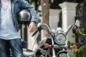 man holding motorcycle helmet
